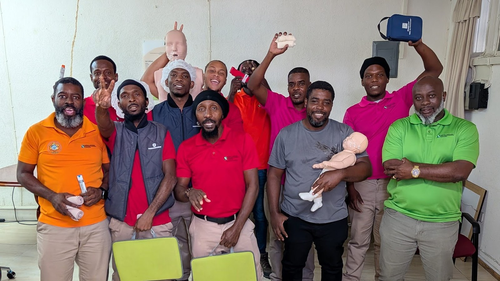 A group of newly certified first aid students celebrating at the end of a CPR and AED course in Barbados